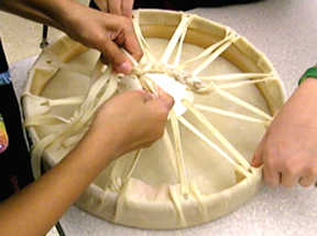 Braiding rawhide lacing into drum handle