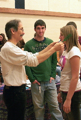 Demonstrating vibrational healing with Solfeggio tuning forks.