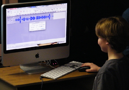 Student manipulates recorded sound of drums with audio editing software.